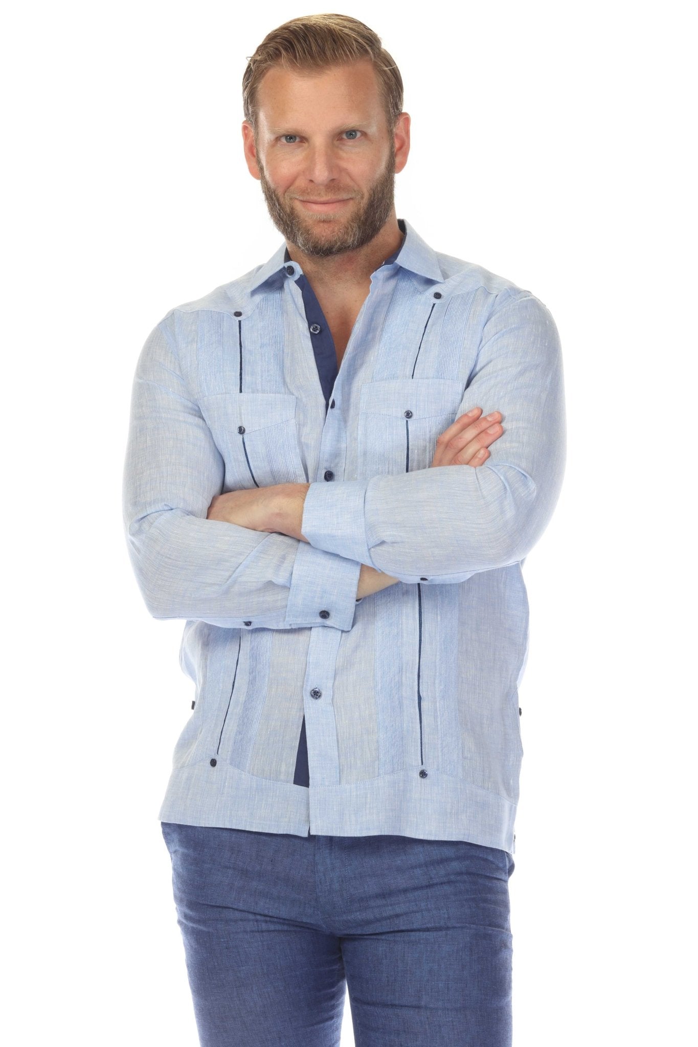 Man in a light blue 100% Linen Contrast Panel Guayabera Shirt Long Sleeve with black detailing; arms crossed.