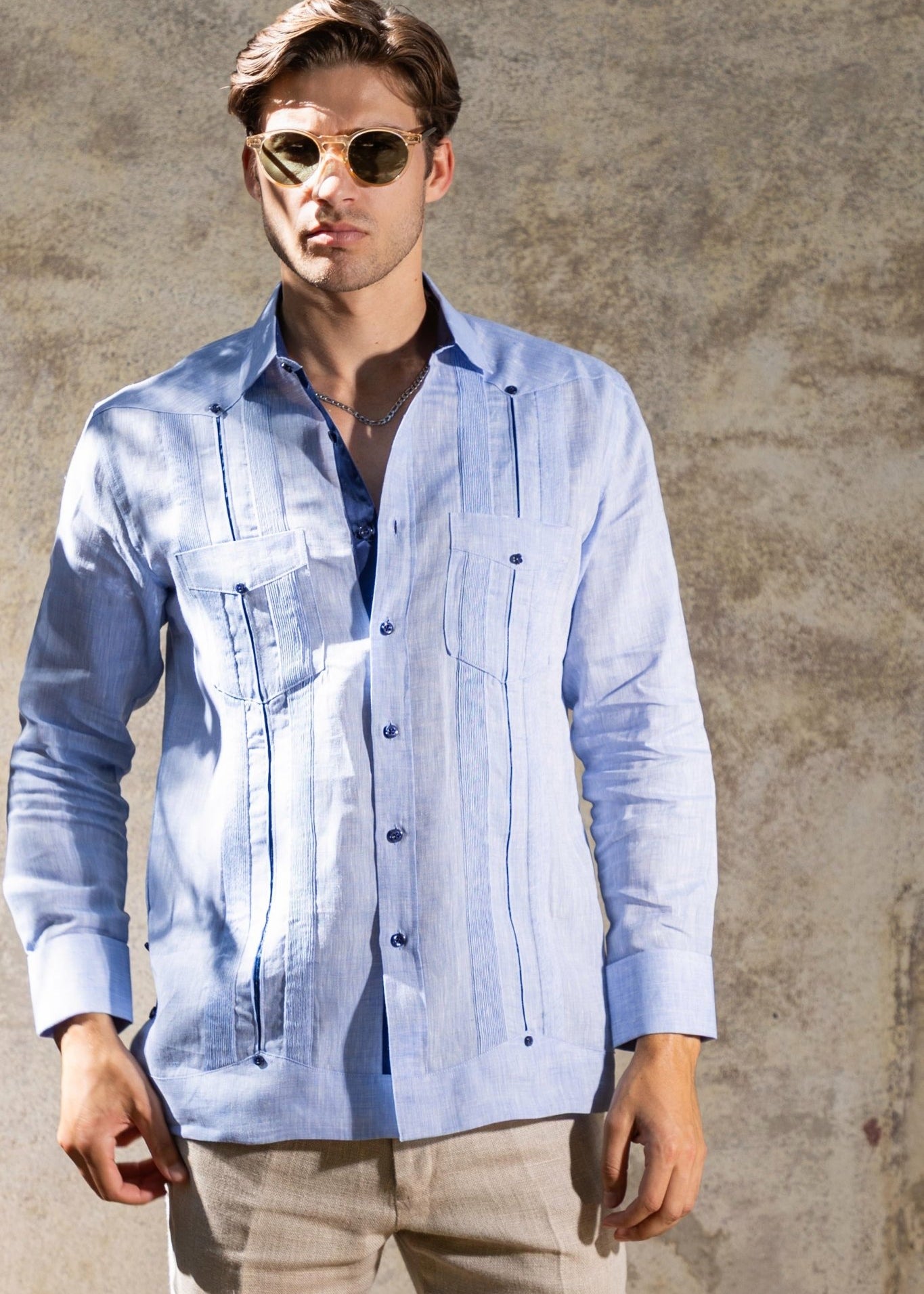 Model wearing a light blue Men's 100% Linen Guayabera with contrast taping and French cuffs.