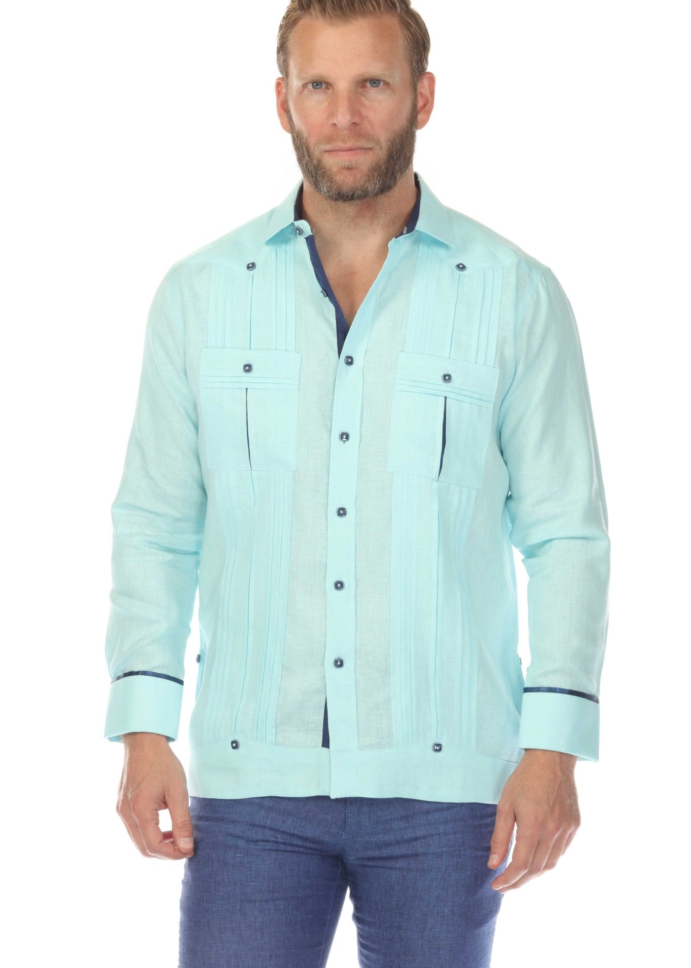 A man models a light blue linen guayabera shirt with two pockets and wide pleating.