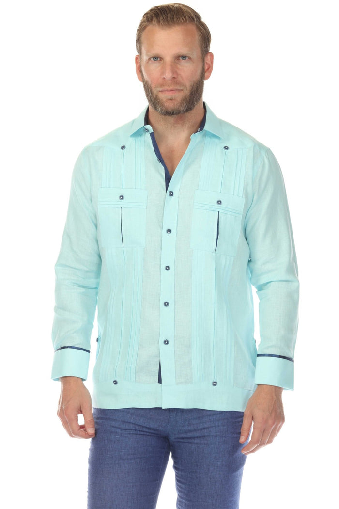 Person in white 100% Linen Contrast Panel Guayabera Shirt, long sleeve, seated, unbuttoning shirt to reveal contrast panel.
