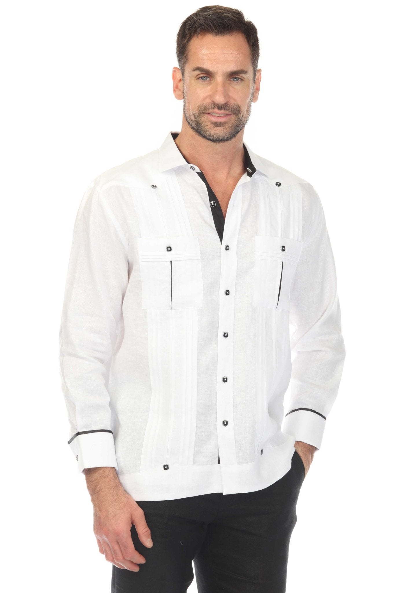 A man wears a white long-sleeve 100% Linen Contrast Panel Guayabera Shirt with black accents.