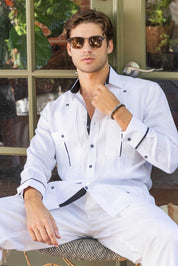 Model wears a white, long sleeve 100% Linen Contrast Panel Guayabera Shirt, unbuttoned at the top, with dark trim.