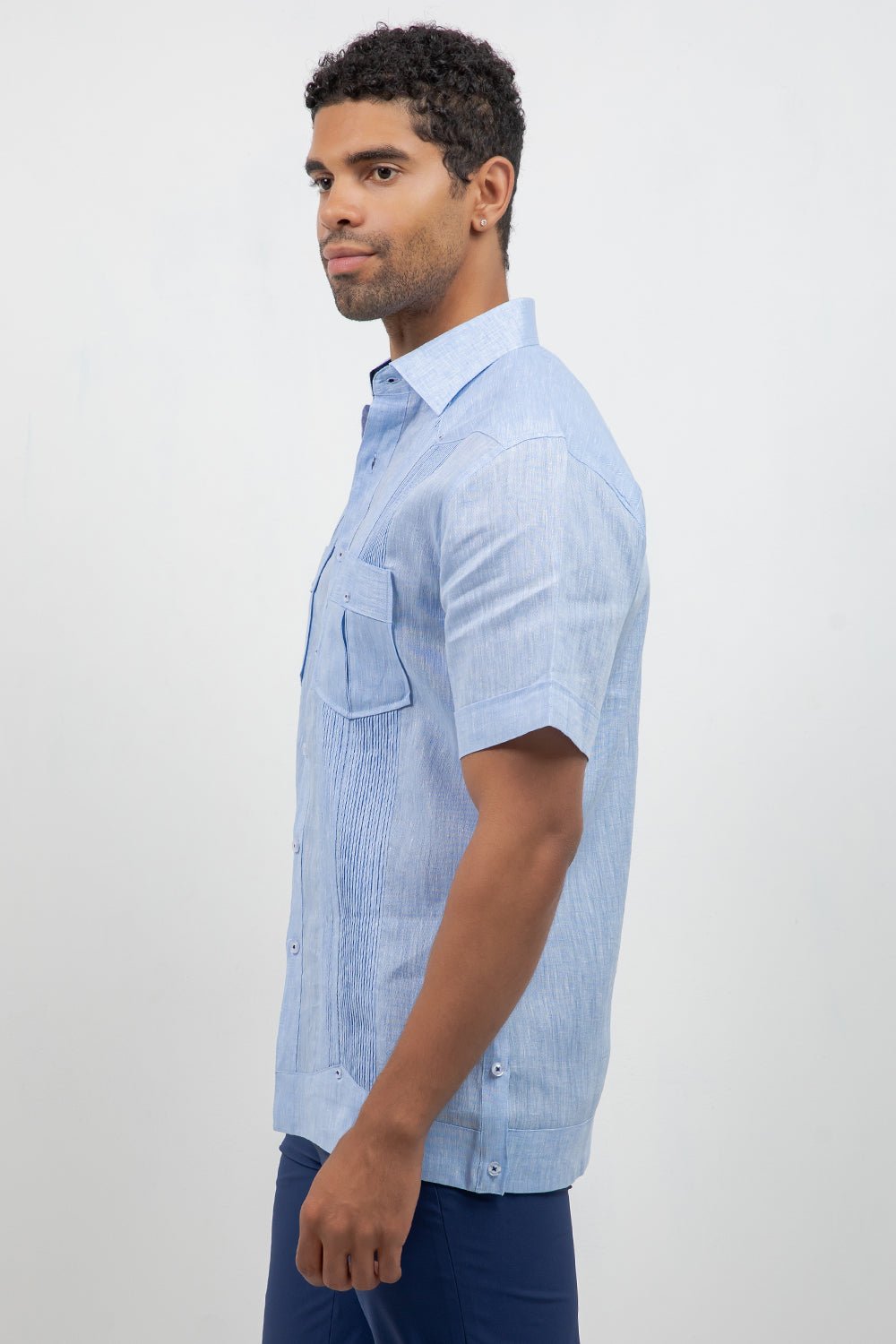 Man wearing a light blue striped shirt on a white background