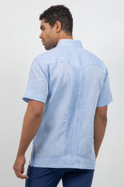 Man wearing a light blue short-sleeve shirt on a white background