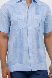 Light blue short-sleeve button-up shirt worn by a person on a plain background