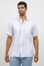 Man wearing a white short-sleeve button-up shirt against a plain background
