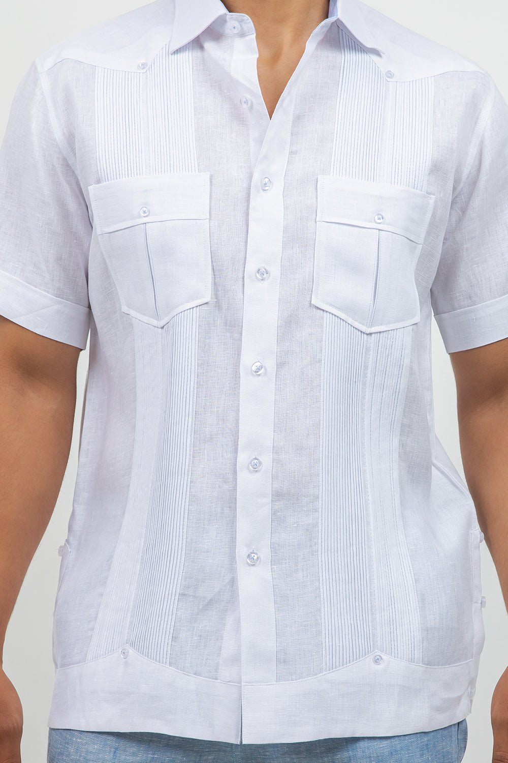 White short-sleeve button-up shirt with a subtle pattern on a plain background