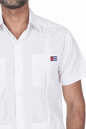 Close-up of the white Limited Edition guayabera showing the embroidered Cuban flag patch on the left chest pocket