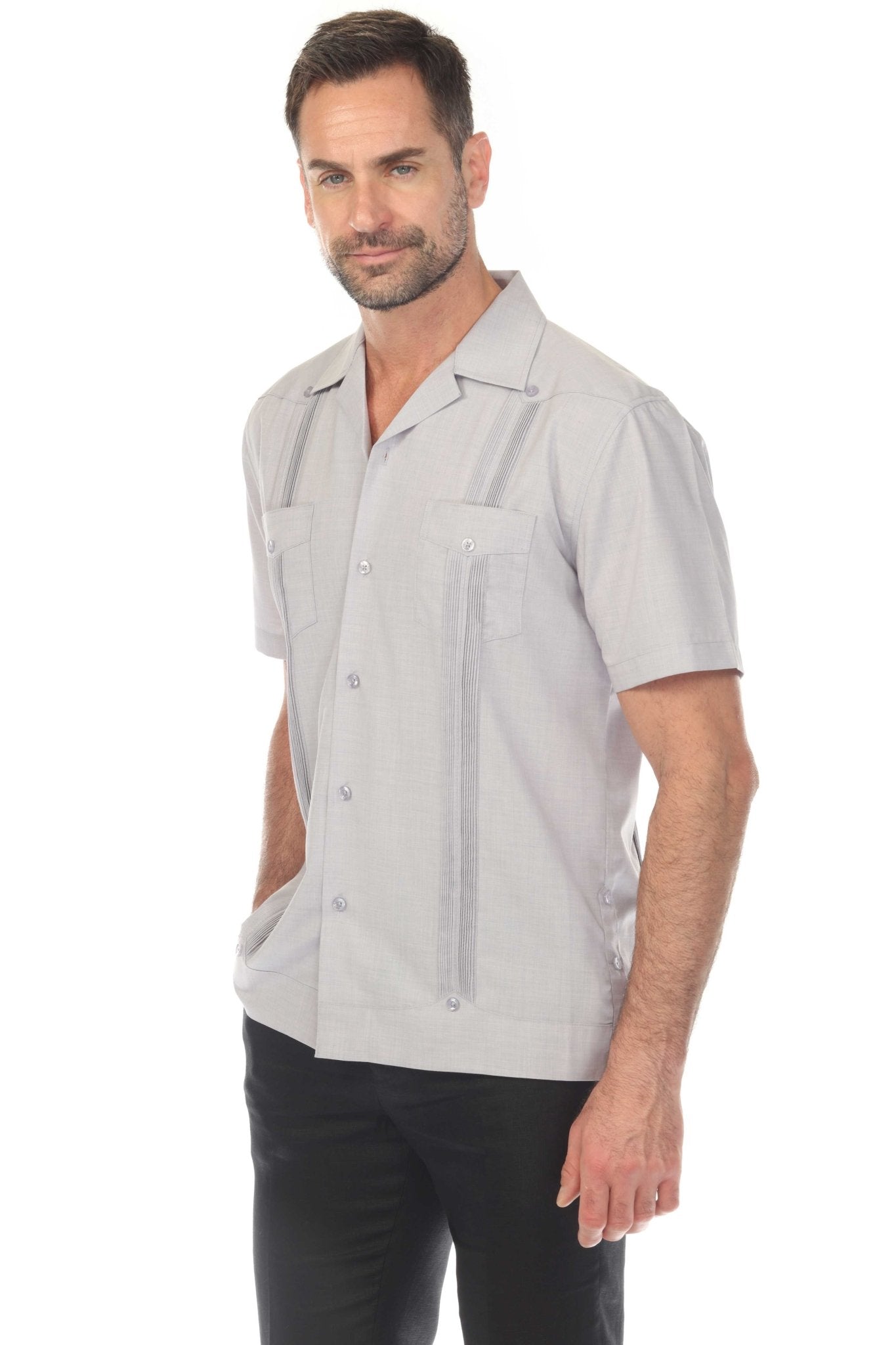 A man models the gray Men’s Two-Pocket Cross-Dye Guayamisa Shirt with Pleats.