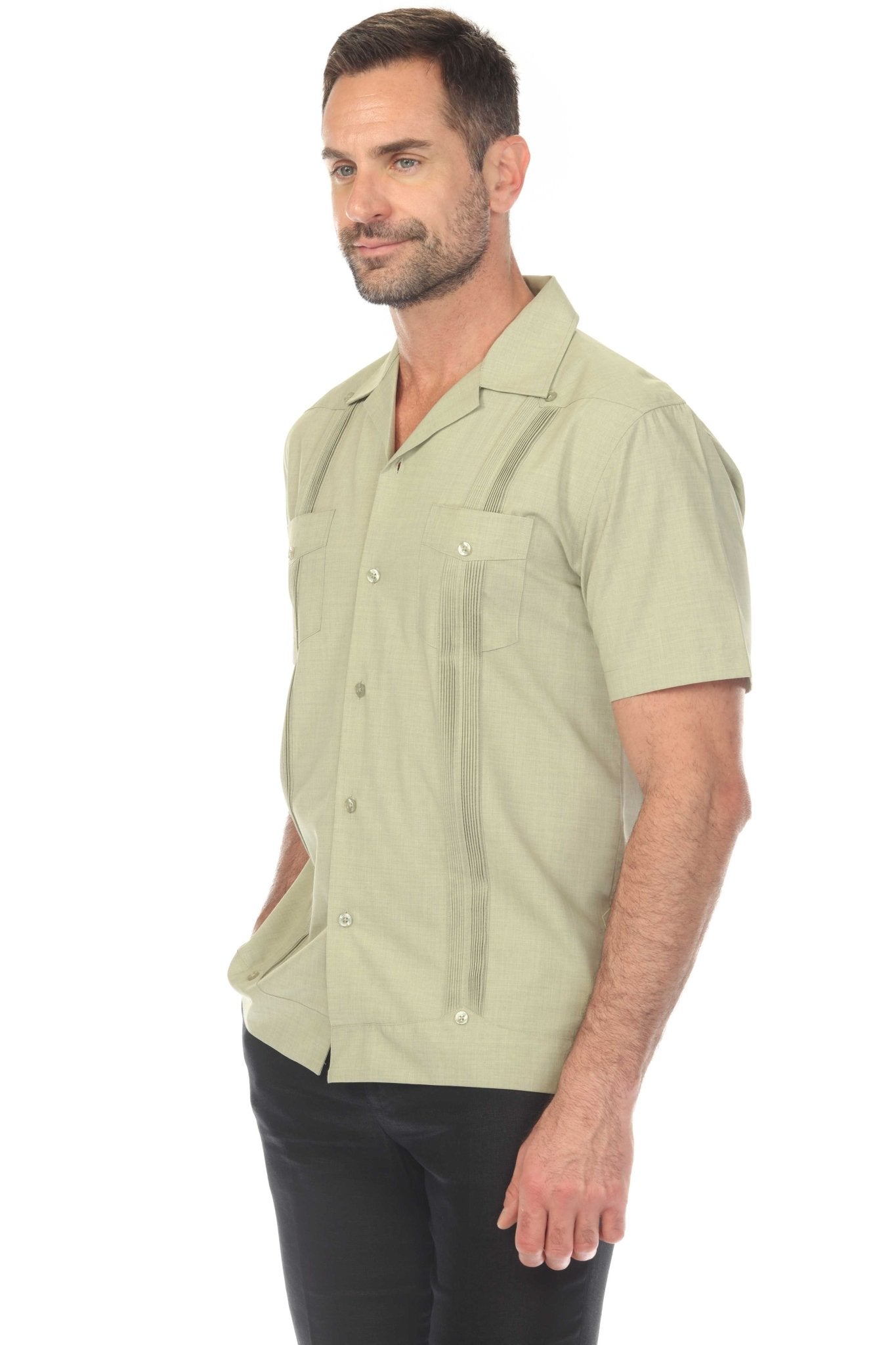 A man wears a green Men’s Two-Pocket Cross-Dye Guayamisa Shirt with Pleats, shown in a side view.