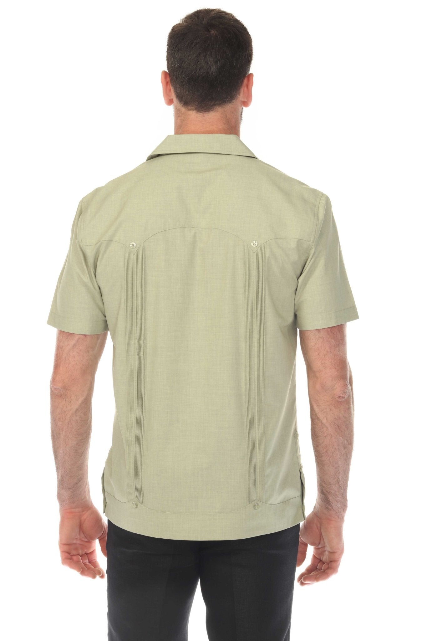Back view of a man wearing the light green Men’s Two-Pocket Cross-Dye Guayamisa Shirt, showing the pleats.