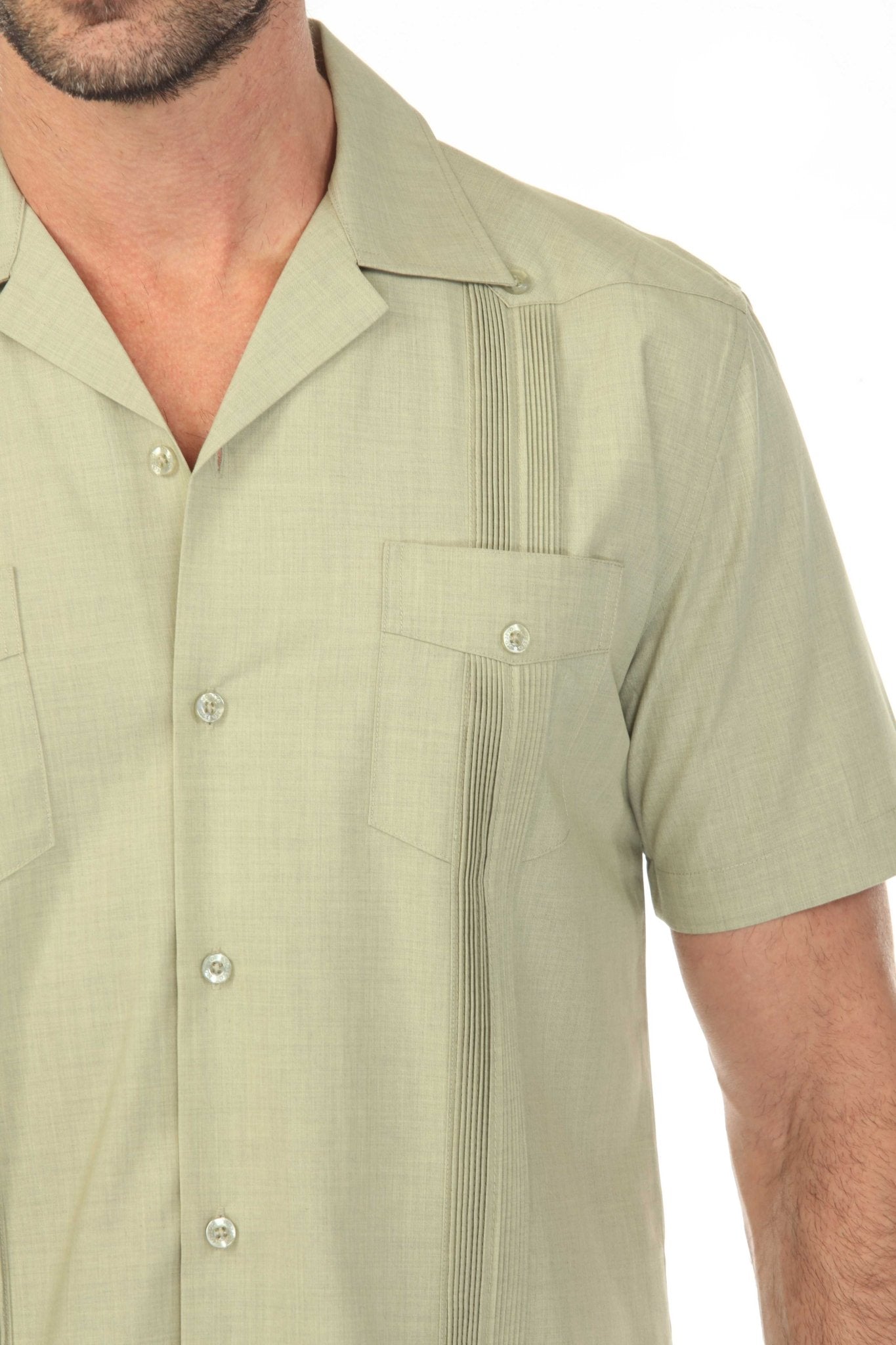 Close-up of a sage green Men’s Two-Pocket Cross-Dye Guayamisa Shirt with pleats on the pockets and side.