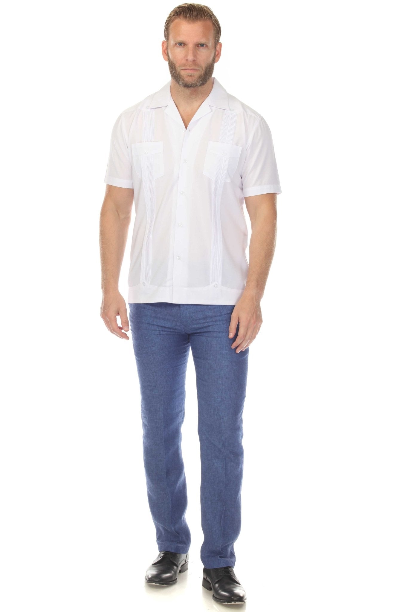 Front view of a man wearing a white Men’s Two-Pocket Cross-Dye Guayamisa Shirt with Pleats, paired with blue jeans.
