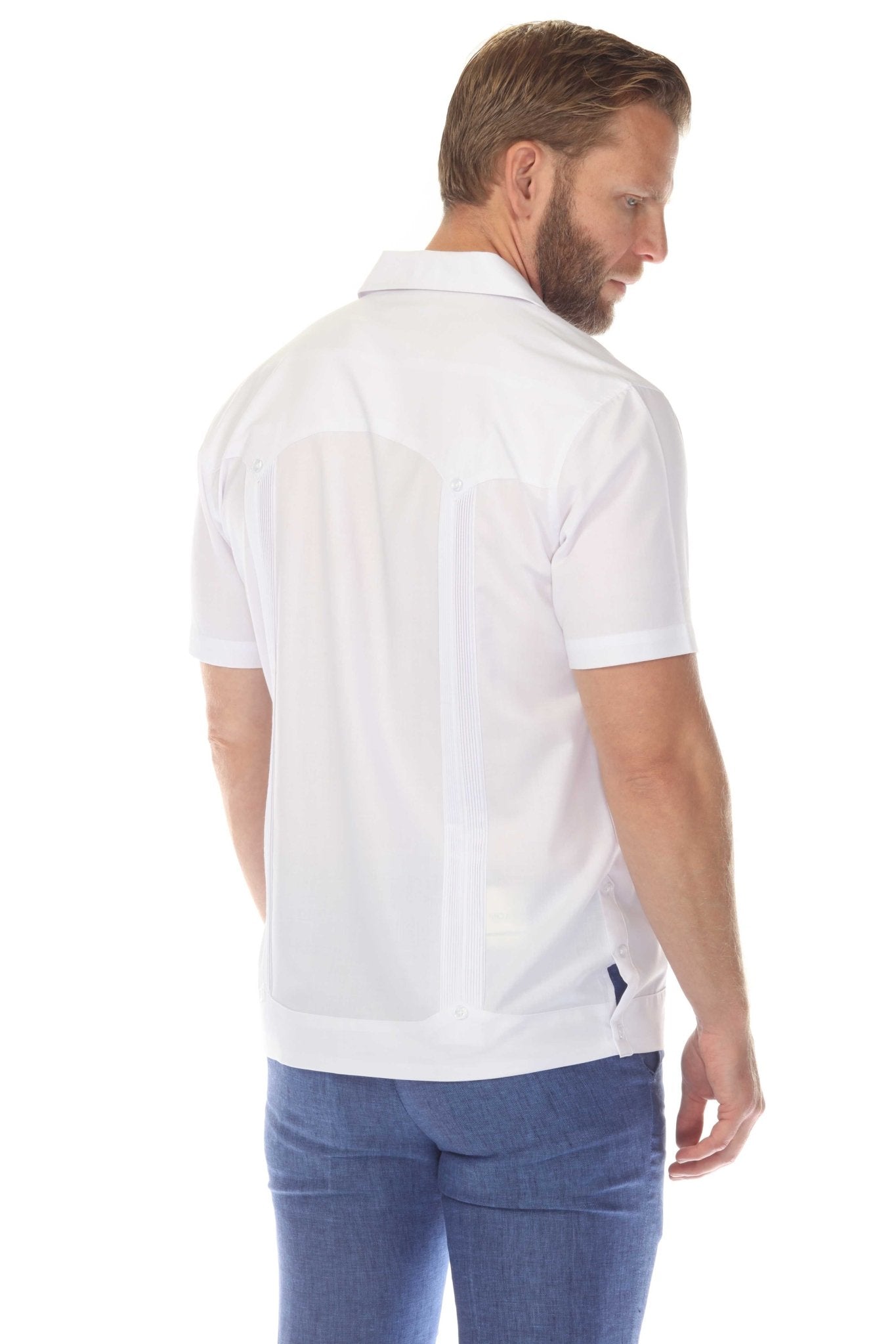 Back view of a man wearing the white Men’s Two-Pocket Cross-Dye Guayamisa Shirt with Pleats.