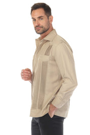 A man models the tan "Men's Long Sleeve Two-Pocket Guayabera Shirt with Pick Stitching" at a side angle, showing the shirt's details.