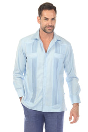 Front view of a man wearing a light blue Men’s Long Sleeve Two-Pocket Guayabera Shirt, showing pick stitching details.