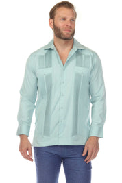 Front view of a man wearing a light blue Men’s Long Sleeve Two-Pocket Guayabera Shirt, detailed with pick stitching.