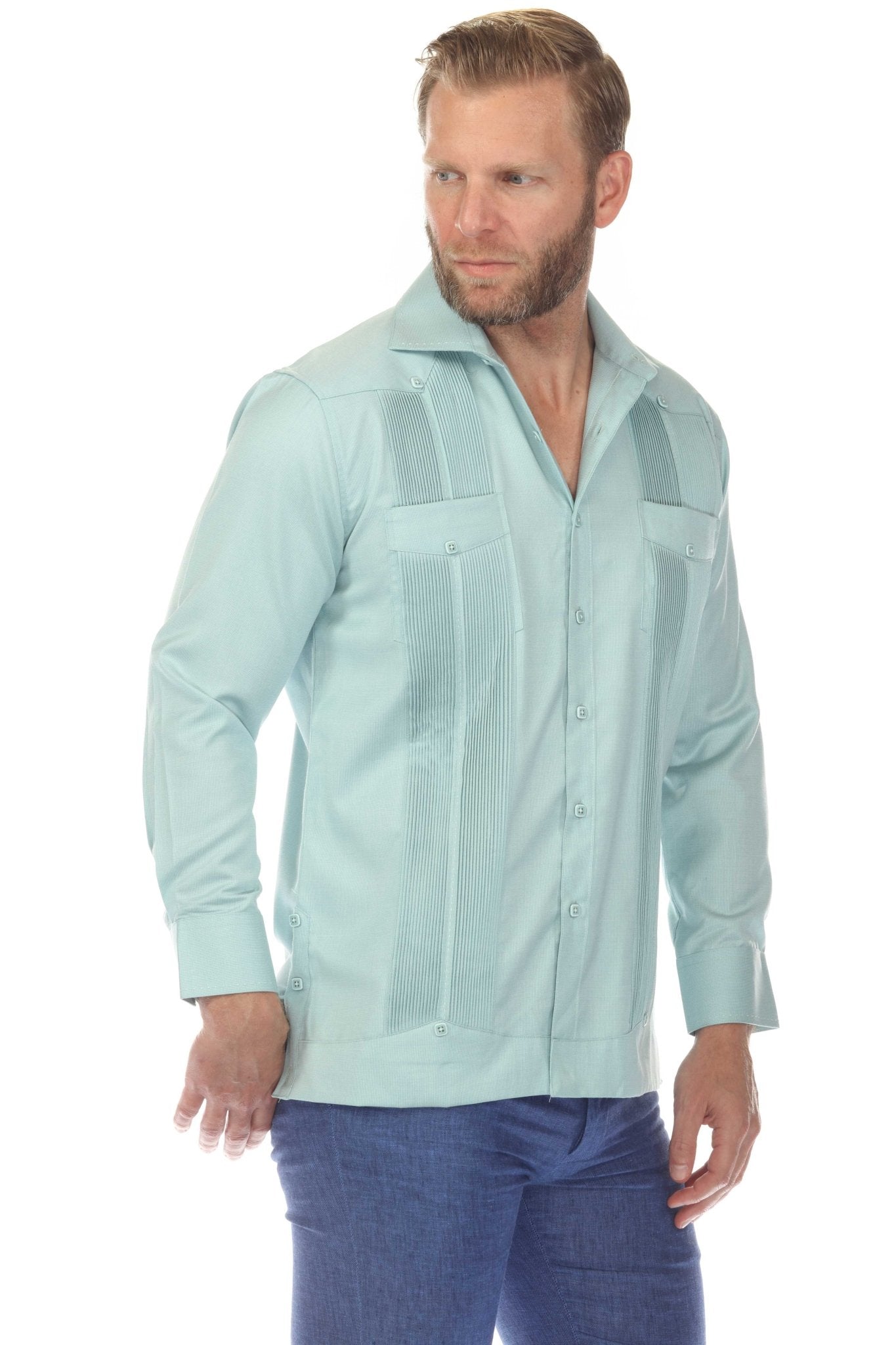 Man in a light blue long sleeve two-pocket Guayabera shirt with pick stitching.