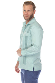 Side view of a man wearing a light green Men’s Long Sleeve Guayabera Shirt with two pockets and pick stitching.