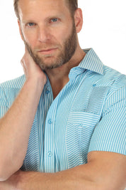 Close-up of a man wearing a blue and white striped Men’s Two-Pocket Guayabera Shirt with Micro Textured Print.
