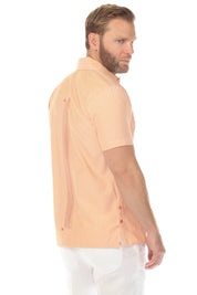 Side view of a man wearing an orange and white striped Men’s Two-Pocket Guayabera Shirt.