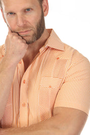 Close-up of a man wearing an orange and white striped Men’s Two-Pocket Guayabera Shirt showing textured detail.