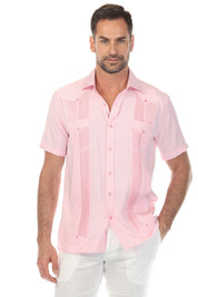A man models a pink and white striped Men’s Two-Pocket Guayabera Shirt with Micro Textured Print.