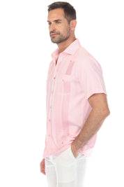 Profile of a man wearing a pink and white striped Men’s Two-Pocket Guayabera Shirt with Micro Textured Print.