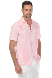 A man models a pink and white striped Men’s Two-Pocket Guayabera Shirt with Micro Textured Print.