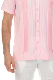 Close-up of a pink and white striped Men’s Two-Pocket Guayabera Shirt with micro textured panels.