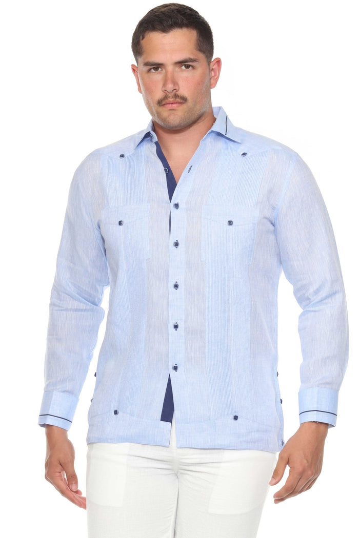 A man stands in a white Contrast Trim Linen Guayabera, showcasing the two pockets and long sleeves.