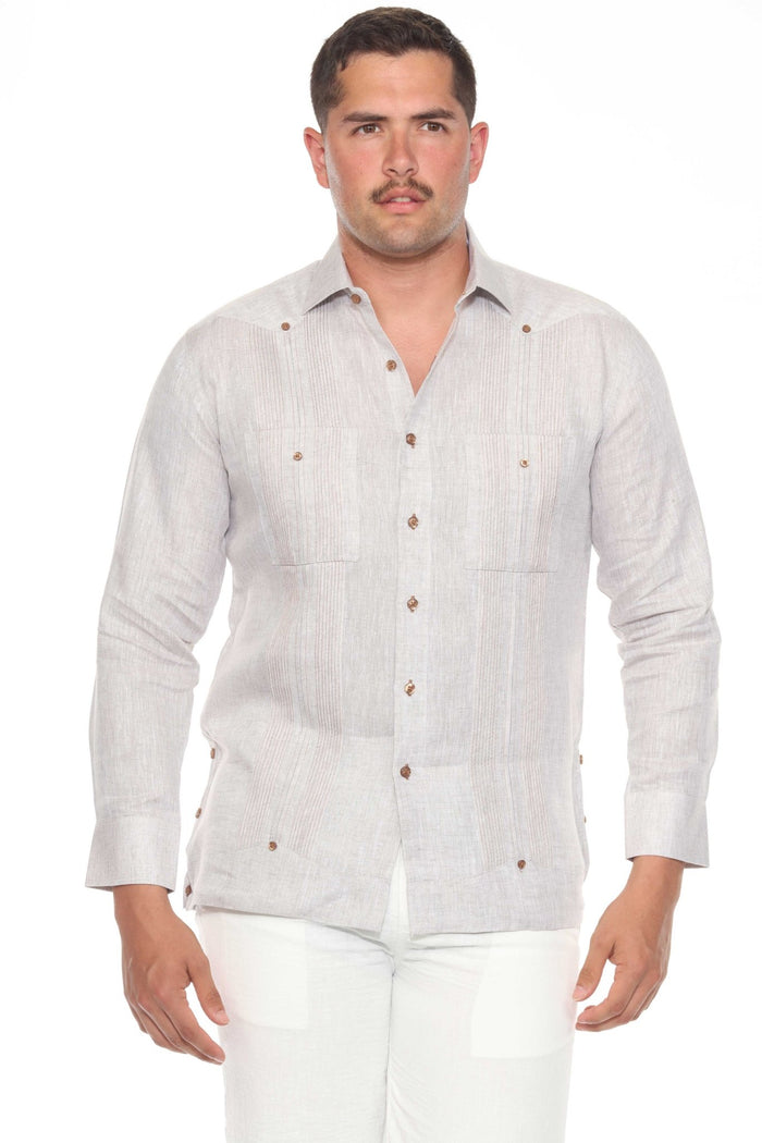 A man wears an off-white long-sleeve Men’s 100% Linen Guayabera Shirt with heritage pleats.