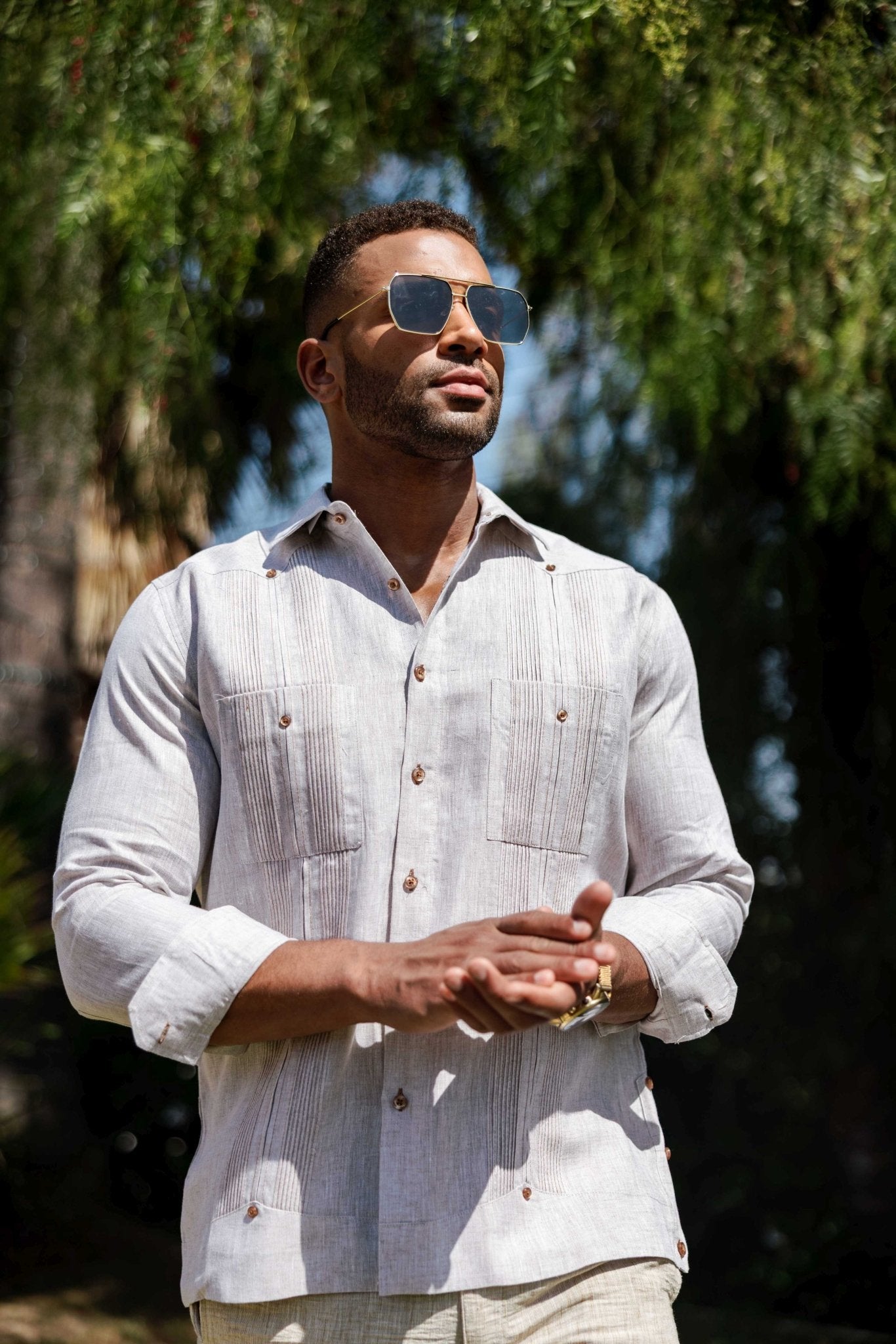 A man models the long-sleeve linen Guayabera shirt in heather with heritage pleats.