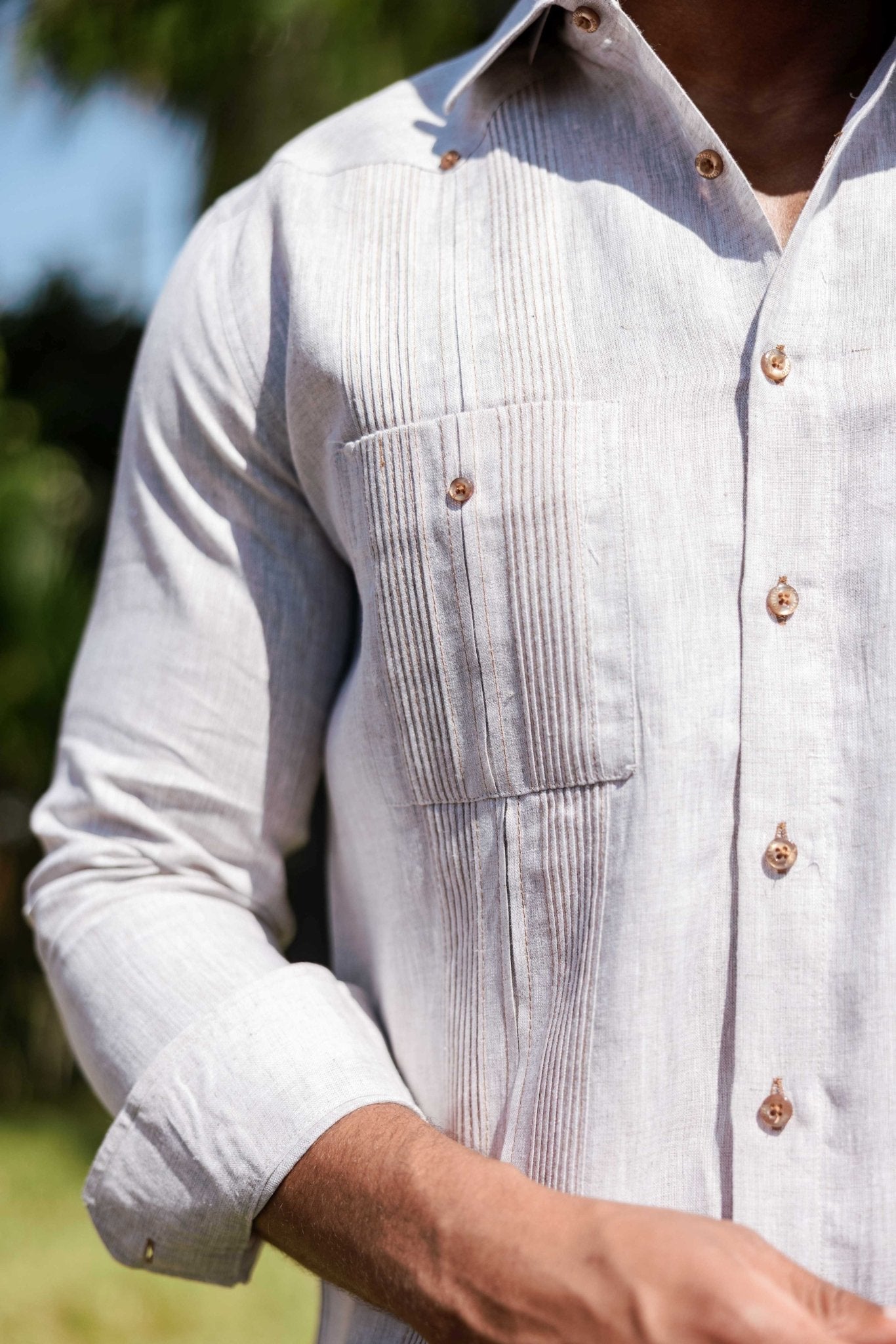 Close-up of a light gray long-sleeve Men’s 100% Linen Guayabera Shirt, showing heritage pleats and button details.