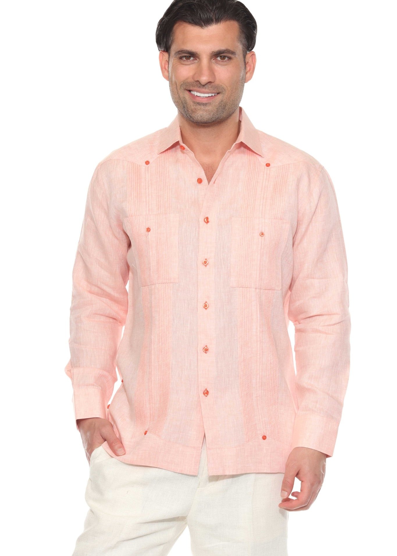 A man smiles wearing a peach long-sleeve Men’s 100% Linen Guayabera Shirt with heritage pleats.