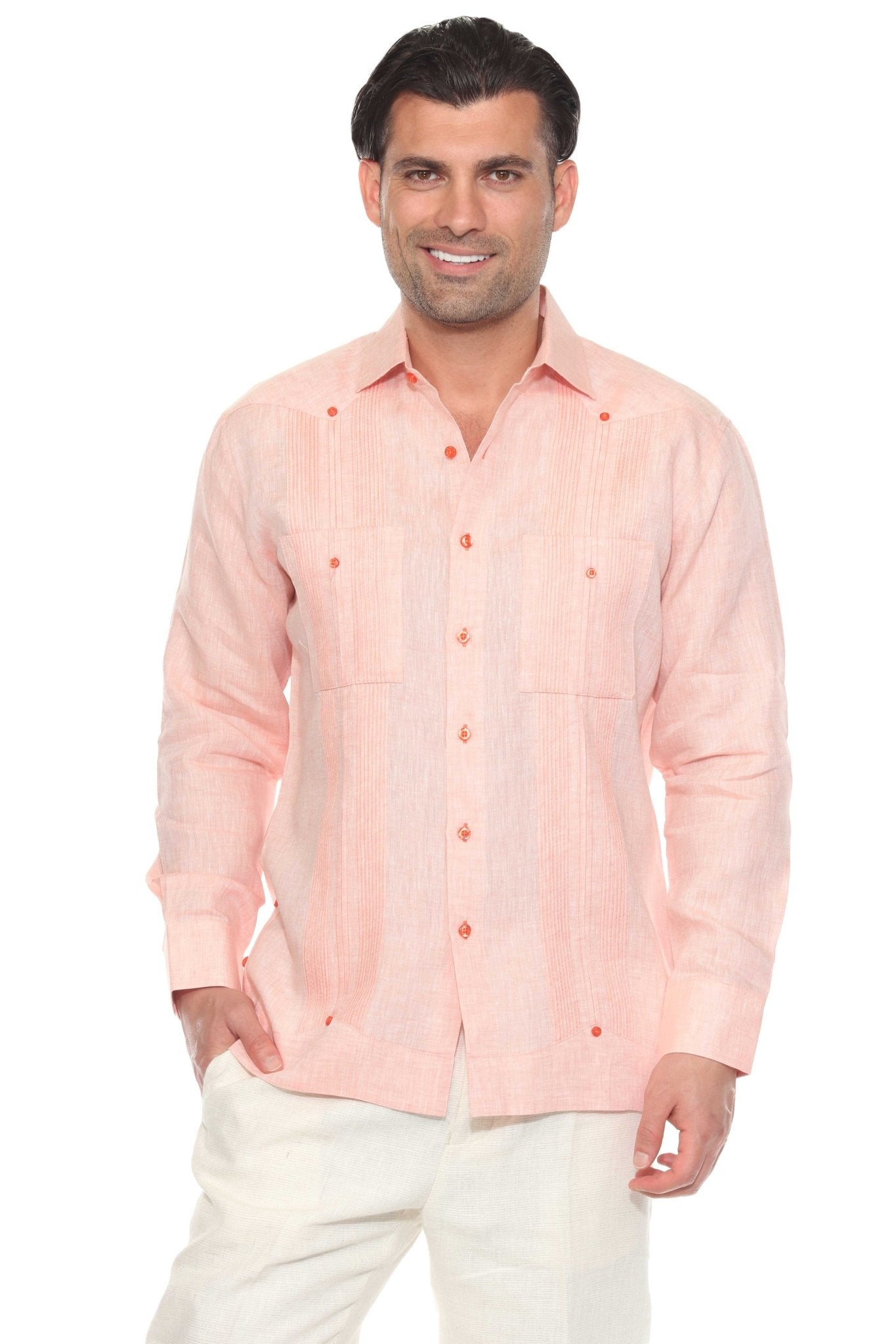 A man smiles wearing a peach long-sleeve Men’s 100% Linen Guayabera Shirt with heritage pleats.