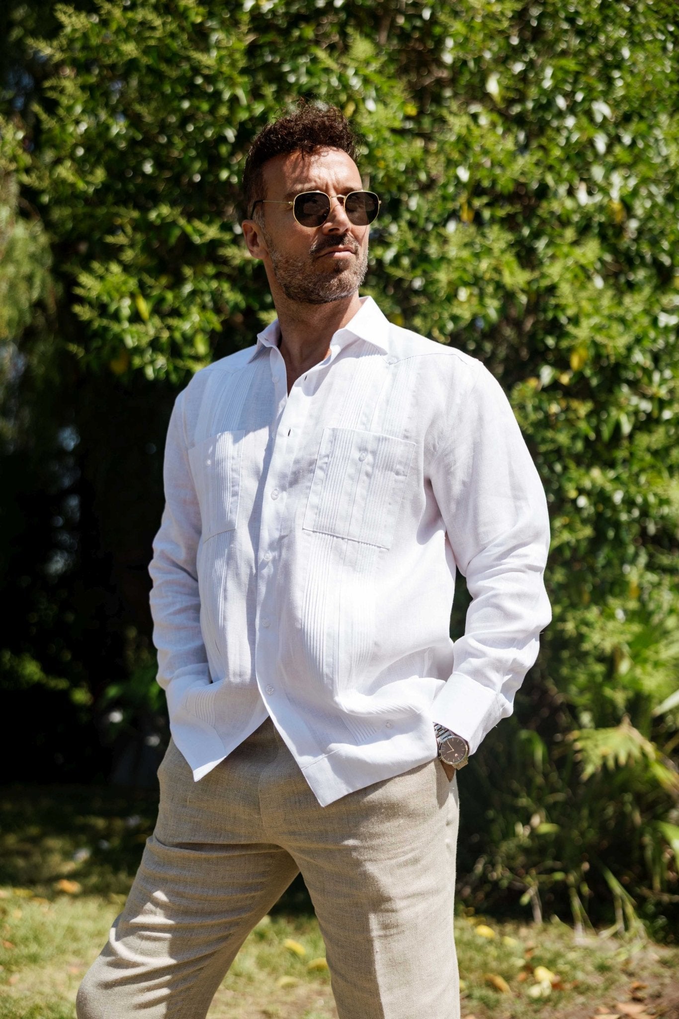Man wearing a white long sleeve Men’s 100% Linen Guayabera Shirt, styled with pleats.