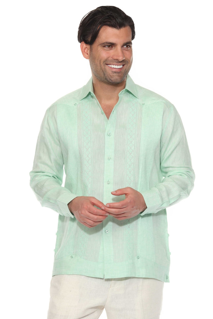 Man wearing a 100% Linen Contrast Panel Guayabera Shirt; long sleeves, light color with detailed contrast paneling.