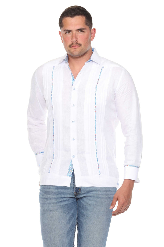 Man wearing a cream 100% linen long sleeve guayabera shirt with blue embroidery and signature pleated front.