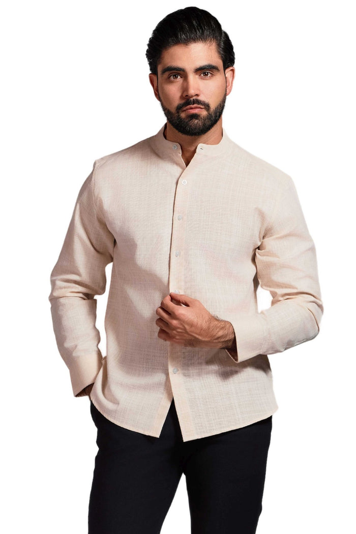 A man wears a light blue Men's Mandarin Collar Long Sleeve Shirt, with his hand in his pocket.