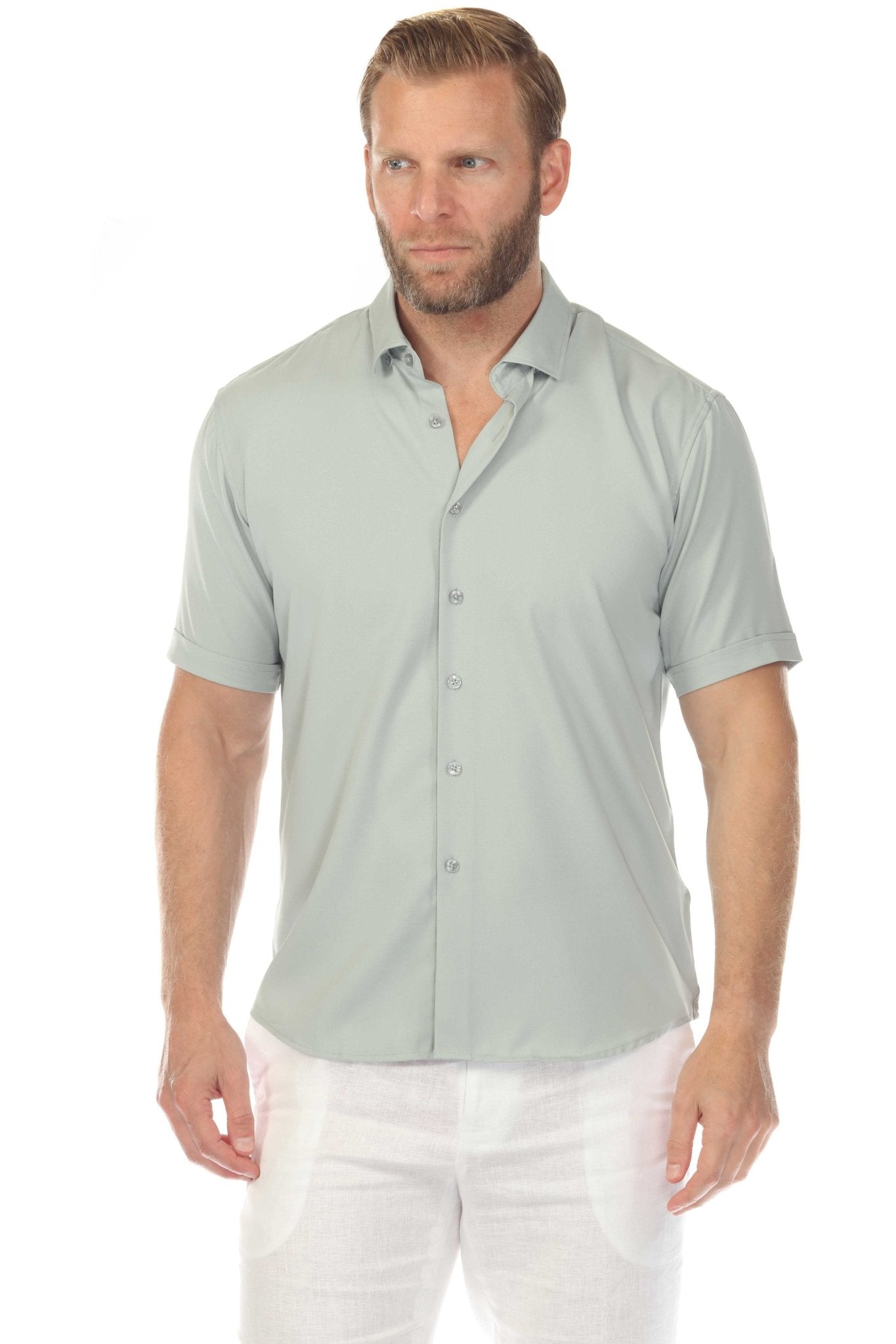 Front view of a man wearing a light gray Menâ€™s Classic 4-Way Stretch Short Sleeve Shirt and white pants.