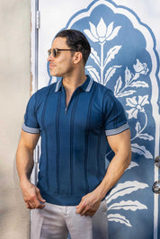Profile view of a man wearing a blue Men's Premium Knit Textured Polo Shirt with Stripe accents.
