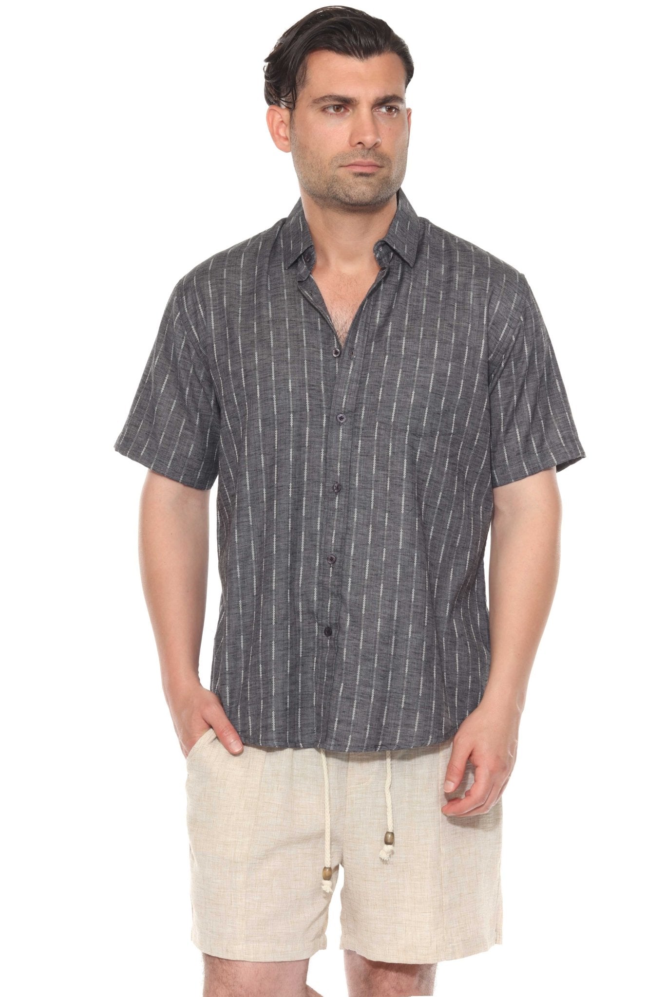 Front view of a man wearing the Men’s Pinstripe Resort Shirt, a gray cotton blend button-up with short sleeves and vertical white stripes.