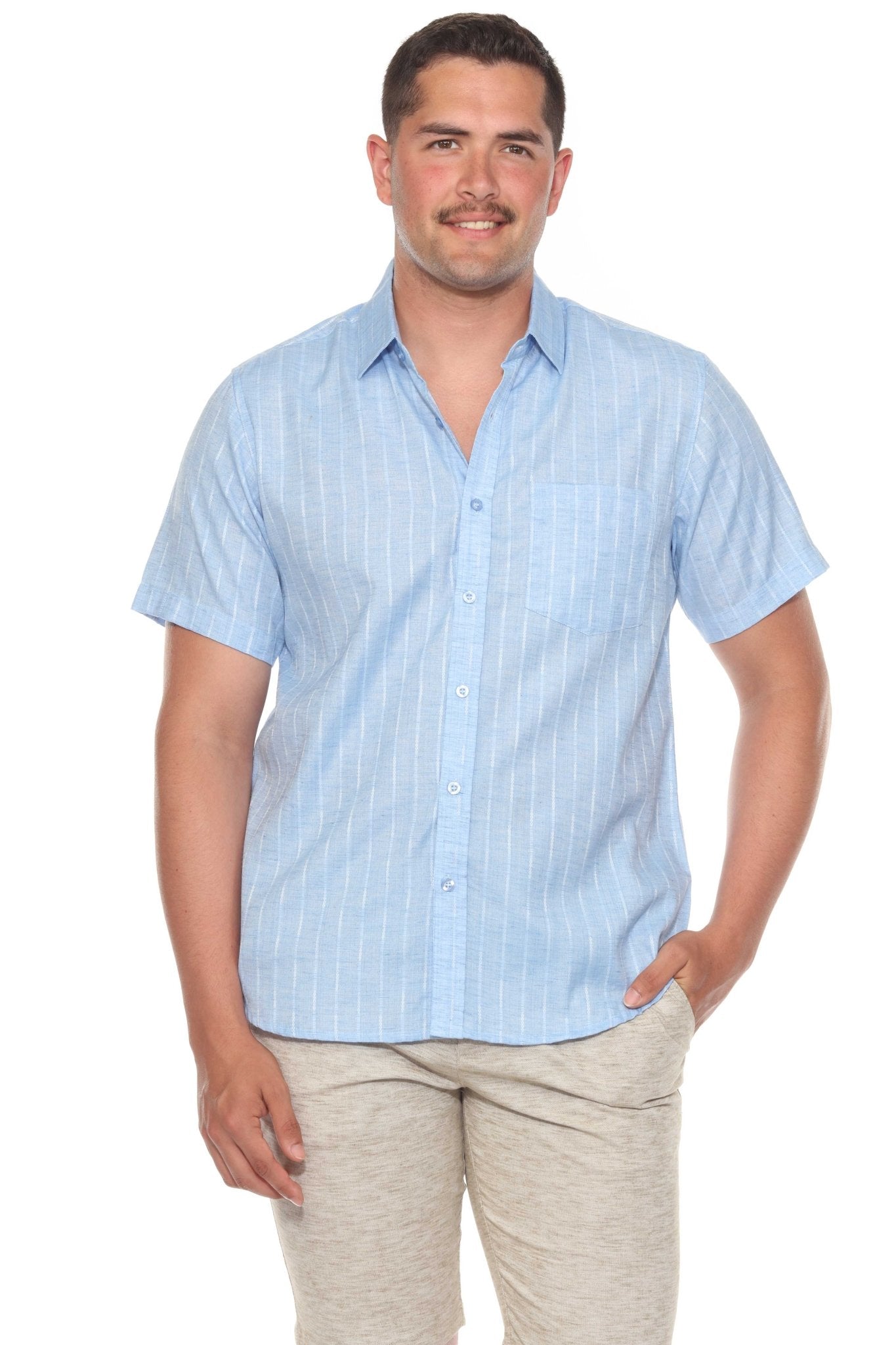 A man wears a light blue Men’s Pinstripe Resort Shirt, a short sleeve button-up, with white pinstripes.