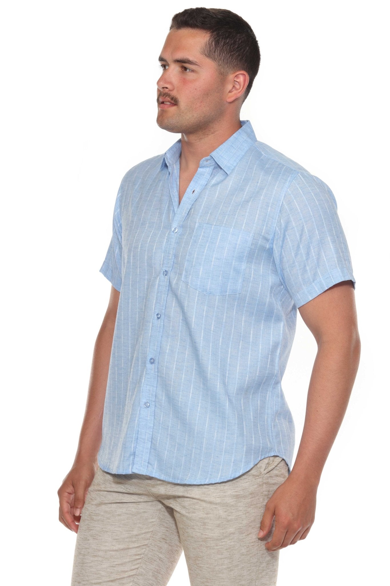 A man models the light blue Men’s Pinstripe Resort Shirt, a cotton blend button-up with short sleeves.