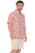 Man wears a pink 100% Cotton Resort Print Short Sleeve Button-Up Shirt with a white leaf pattern.