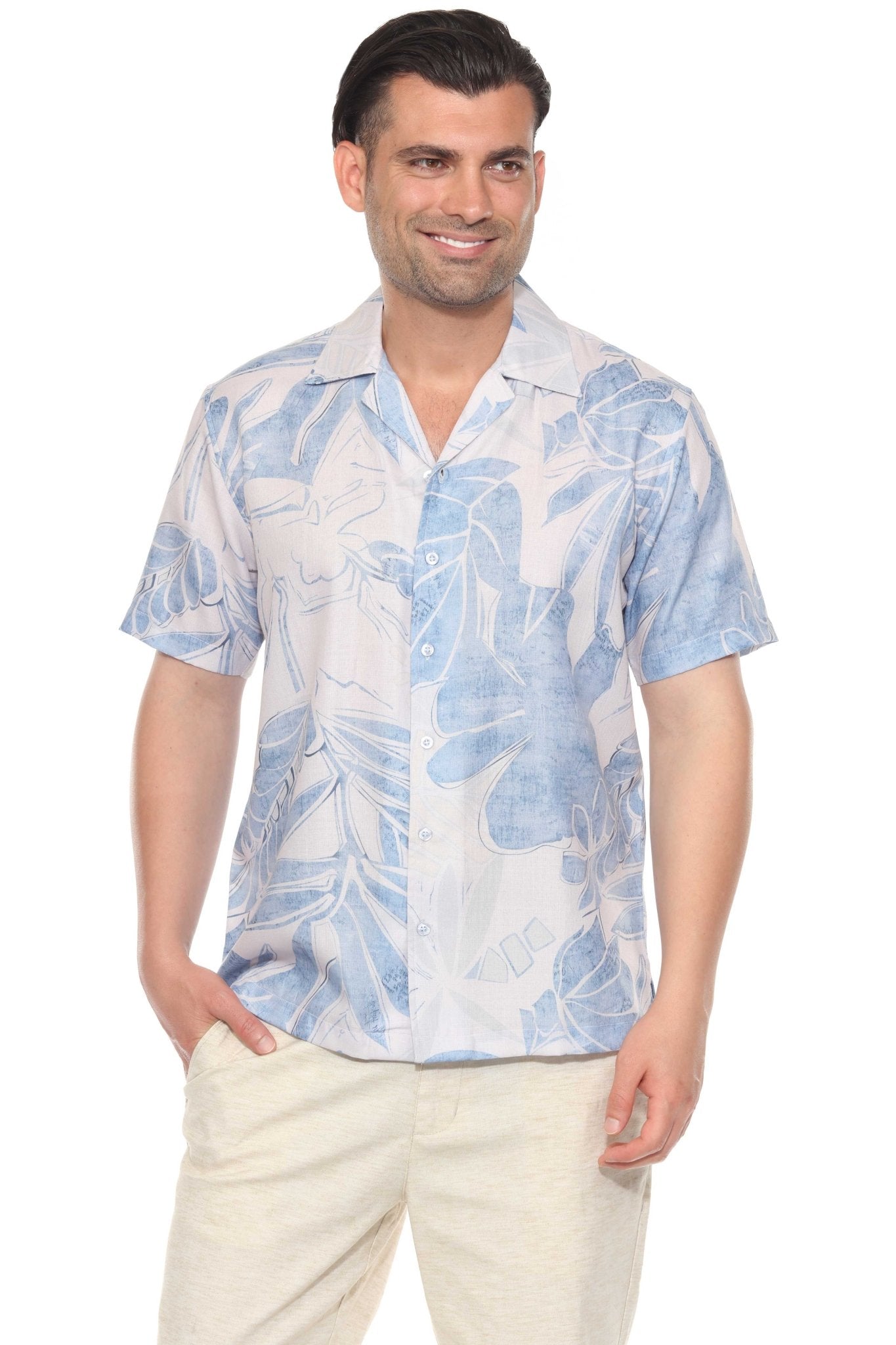 Front view of a man smiling, wearing the blue tropical print resort shirt with cream-colored pants.