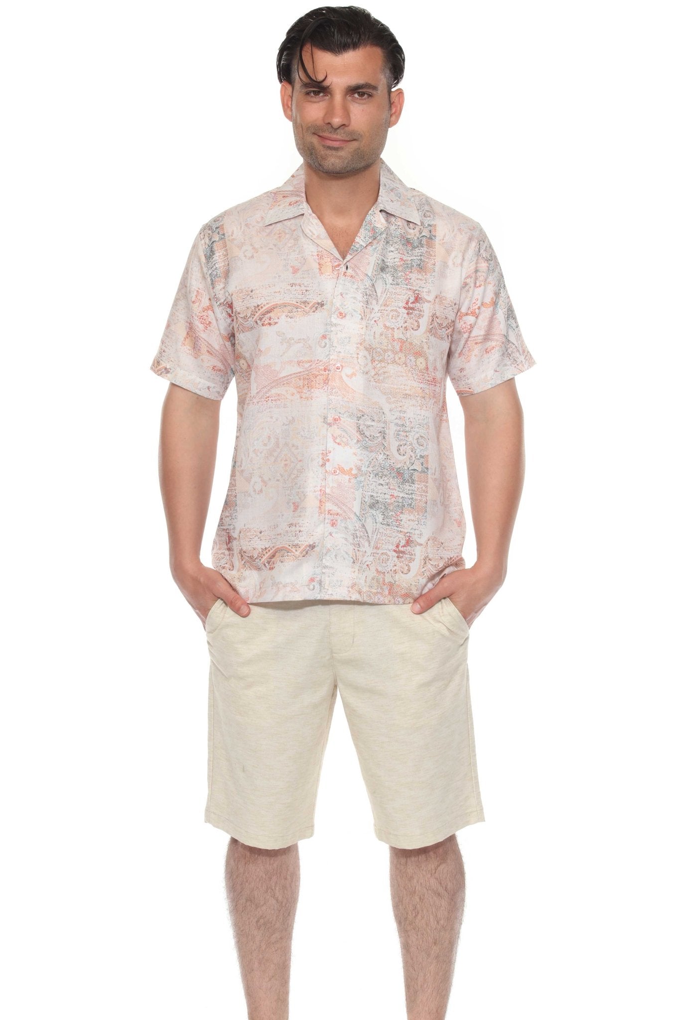 A man faces forward wearing the Tropical Print Resort Shirt, which is a button-up in light pink and orange paisley.