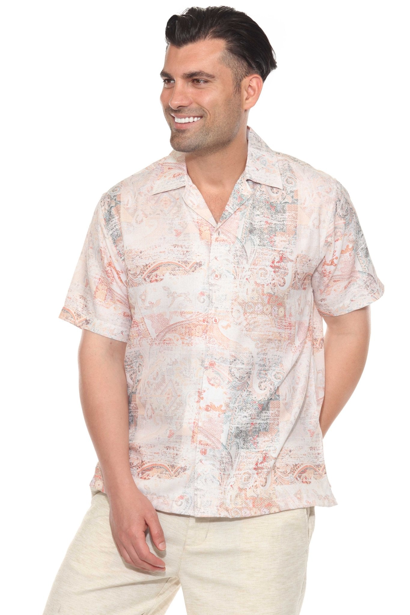 Smiling man wears a white-based Men's Tropical Print Resort Shirt, with short sleeves and a button-up closure.