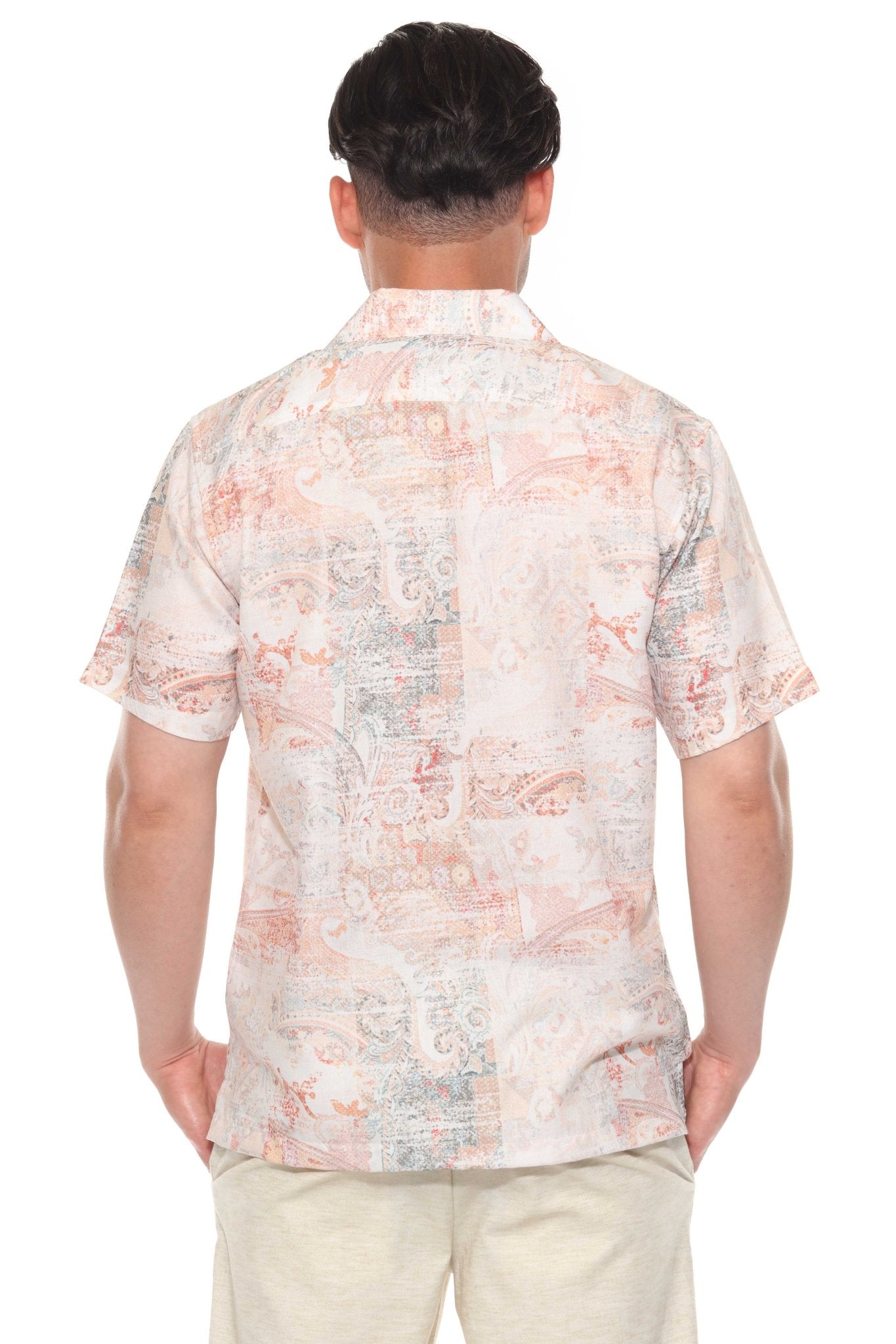Back view of a man wearing a peach tropical print Men's Resort Shirt's with short sleeves.